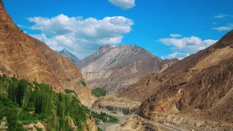 Gorge among the mountains, trees and clouds in the blue sky Stock Footage 196804778