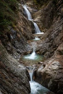 A gorge with a waterfall in the mountains 写真素材
