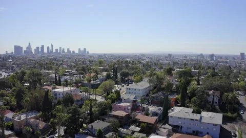 Gorgeous aerial palm tree lined hills Downtown LA in distance Vídeos de archivo 133687448