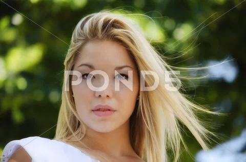 Gorgeous blonde girl headshot outdoors Stock Photos