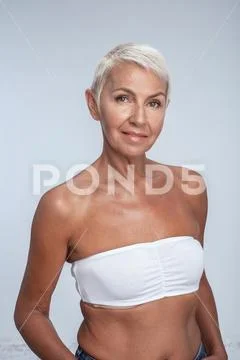 Gorgeous blonde middle aged woman posing in bra Stock Photos