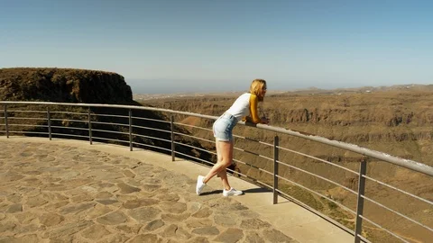 Gorgeous Blonde Model Leaning Forward Railing Sight Seeing the Valley Video stock 114324548
