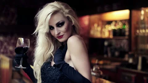 Gorgeous blonde woman by the bar counter with wine, steadicam shot HD Stock Footage
