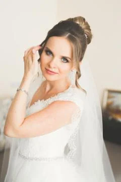 Gorgeous bride in robe posing and preparing for the wedding ceremony face in a Stock Photos