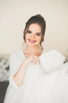 Gorgeous bride in robe posing and preparing for the wedding ceremony face in a Stock Photos