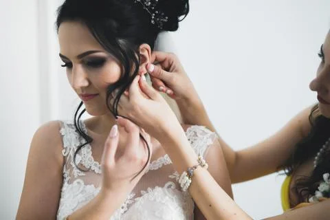 Gorgeous bride in robe posing and preparing for the wedding ceremony face in a Stock Photos