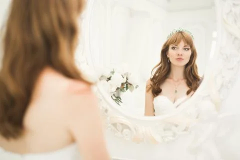 Gorgeous bride in robe posing and preparing for the wedding ceremony face in a Stock Photos