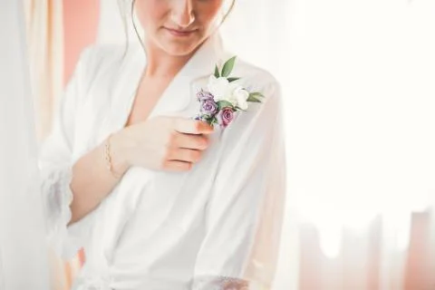 Gorgeous bride in robe posing and preparing for the wedding ceremony face in a Stock Photos