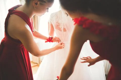 Gorgeous bride in robe posing and preparing for the wedding ceremony face in a Stock Photos