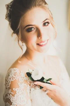 Gorgeous bride in robe posing and preparing for the wedding ceremony face in a Stock Photos