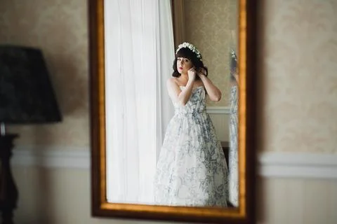Gorgeous bride in robe posing and preparing for the wedding ceremony face in a Stock Photos