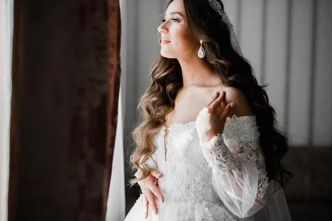 Gorgeous bride in robe posing and preparing for the wedding ceremony face in a Stock Photos