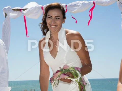 Gorgeous bride standing under sea at summer Stock Photos