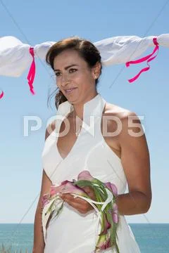 Gorgeous bride standing under sea at summer Stock Photos