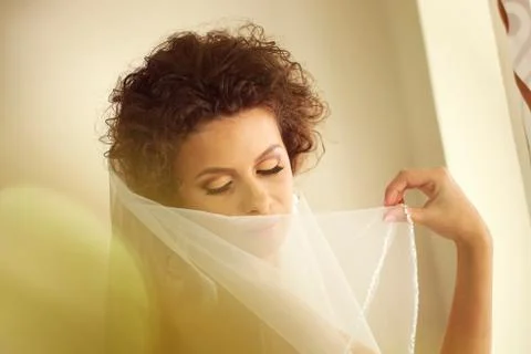 Gorgeous bride with veil posing Stock Photos