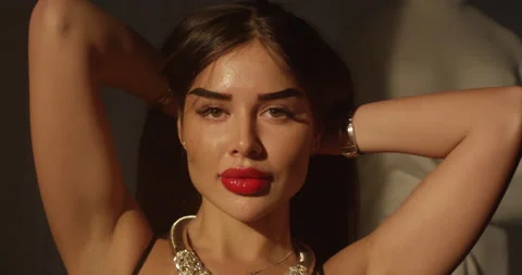 Gorgeous brunette model in a black evening dress with red lips. Beau Stock Footage 164411368