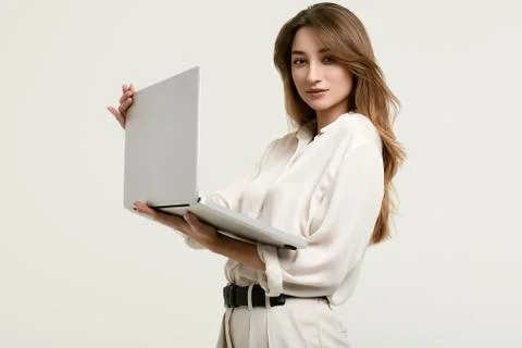Gorgeous brunette model posing in white clothes with laptop Stock Photos