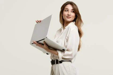 Gorgeous brunette model posing in white clothes with laptop Stock Photos