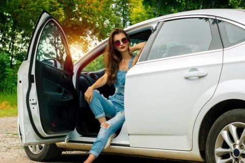 Gorgeous brunette posing while sitting in a car Stock Photos