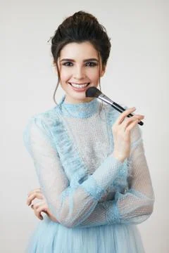 Gorgeous charming lady using a brush Stock Photos