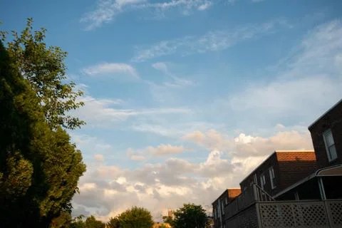 A Gorgeous Cloudy Sunset Sky Behind a Row of Houses in Philladelphia Stock Photos