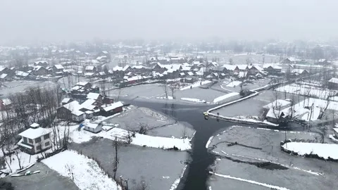Gorgeous drone shot of the interiors of Dal lake under snowfall, highlighting Stock Footage 310223084
