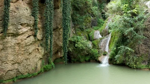 Gorgeous drone shot of small waterfall in the mountains Video stock 112860122