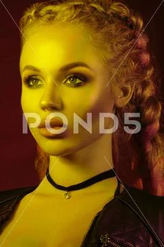 Gorgeous fashionable woman in the lights. pink and yellow light Stock Photos