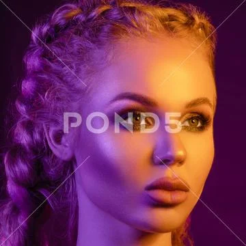 Gorgeous fashionable woman in the lights. pink and yellow light Stock Photos