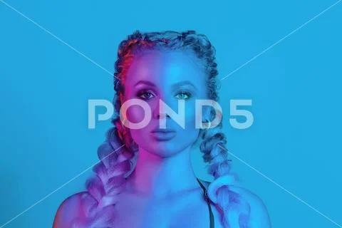 Gorgeous fashionable woman in the lights.blue and red light Stock Photos