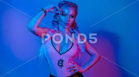 Gorgeous fashionable woman in the lights.blue and red light Stock Photos