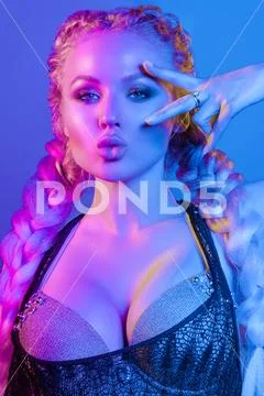 Gorgeous fashionable woman in the lights.blue and red light Stock Photos