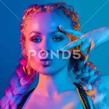 Gorgeous fashionable woman in the lights.blue and red light Stock Photos