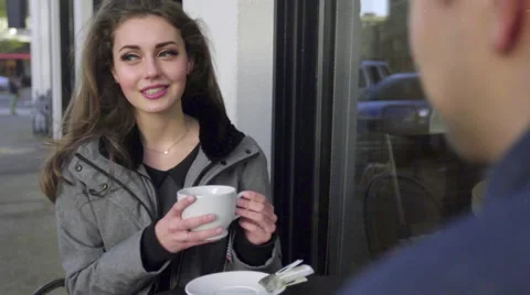 Gorgeous female model drinks a coffee outside a shop Stock Footage 61715570