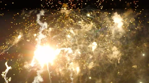 Gorgeous firework exploding in a pitch black sky during New Years Eve with Stock Footage 299833692