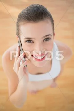 Gorgeous fit brown haired model in sportswear making a phone call Stock Photos