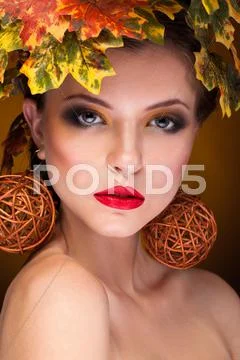 Gorgeous girl with autumn make up and leaves Stock Photos
