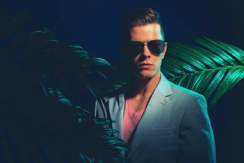 Gorgeous Guy with Shades Standing Between Plants Stock Photos