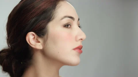 Gorgeous hispanic brunette model critically evaluates appearance in mirror Stock Footage 193911177