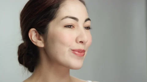 Gorgeous hispanic model confidently smiles, purses lips to smooth out lipstick 스톡 동영상 193888797
