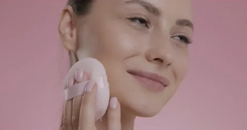 Gorgeous lady applying light powder on face with puff Stock Footage 158755128