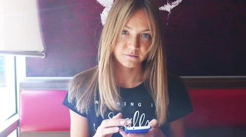 Gorgeous lady using smartphone in cafe drinking coffee smiling Stock Footage 56775853