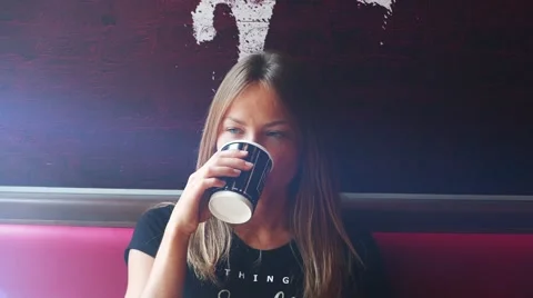 Gorgeous lady using smartphone in cafe drinking coffee smiling. Sunny morning Video stock 56784004