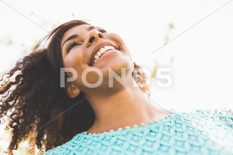 Gorgeous laughing brunette standing in sunlight Stock Photos