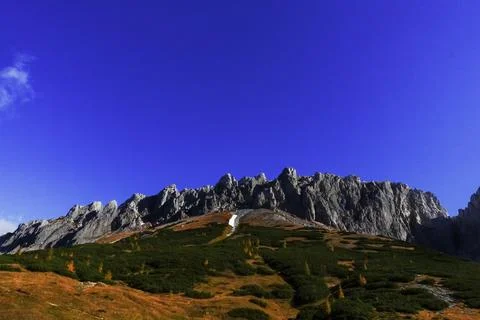 Gorgeous mountain range with deep blue sky while hiking Stock Photos