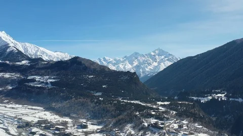 Gorgeous mountain range with snow covered peaks and lots of trees at the bottom Stock Footage 106438801