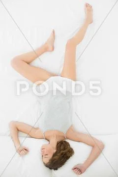 Gorgeous napping woman lying in her bed Stock Photos
