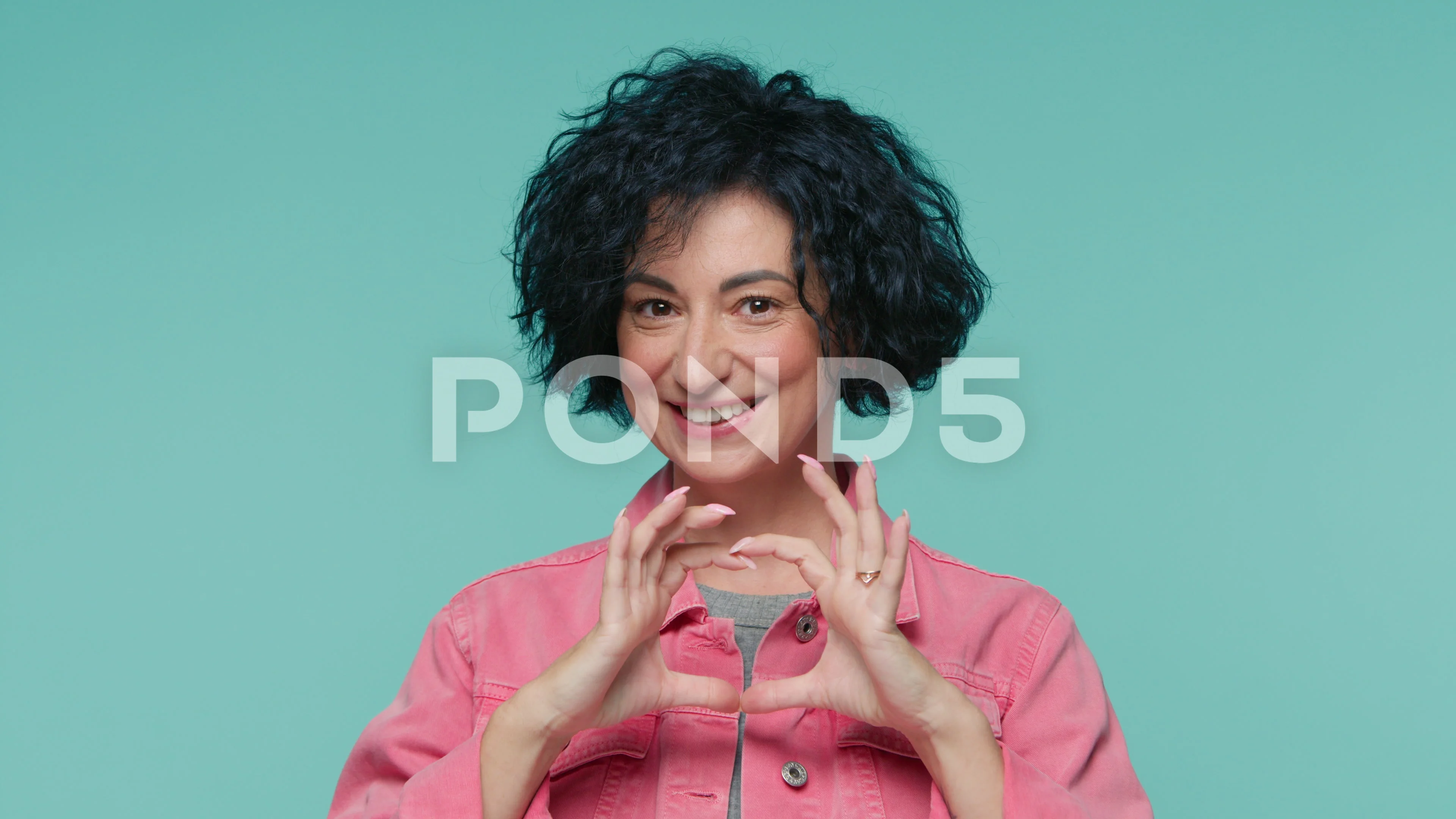 Gorgeous positive mature woman show heart sign make symbol with hands, love  sign