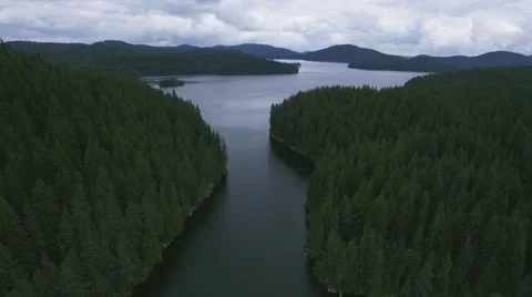 A GORGEOUS PULL BACK TO REVEAL THE WHOLE LAKE AND WOODS AND MOUNTAINS Stock-Footage 65374492