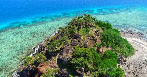 Gorgeous Pull Back View of a Tiny Rock Island in the Fiji Islands Stock Footage 98847844